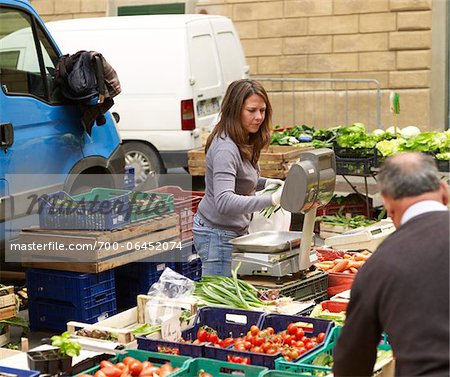 vendors sell vegetables at village farmers market, Cortona, Tuscany, Italy
