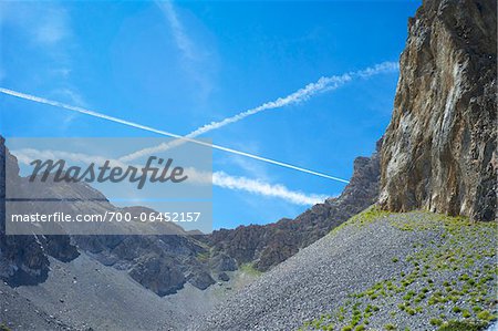 Jet Contrails in Blue Sky over Mountain Frontier between France and Italy, Stroppo, Italy