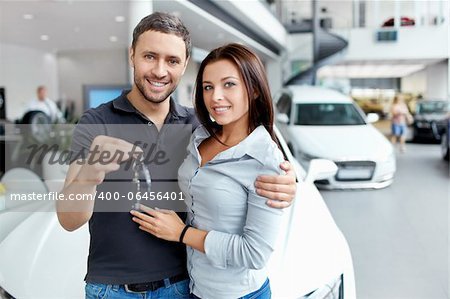 Young couple beside the car