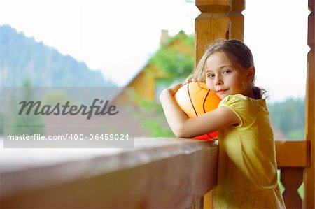 little girl in the wooden house in summer vacation