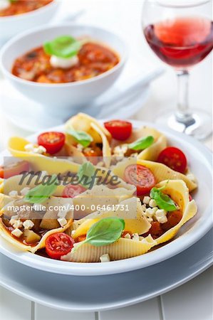 Pasta with vegetable stew with red wine and minestrone soup in back