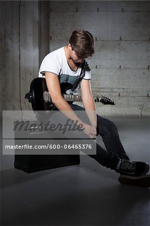 Young Man Holding Electric Guitar Young Man Holding Electric Guitar