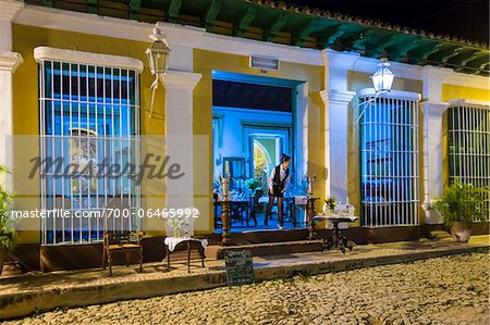 Waitress Looking Out Door of Restaurant Museo at Night, Trinidad, Cuba