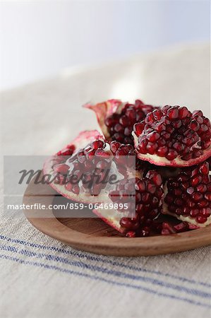 Pomegranates on a wooden plate