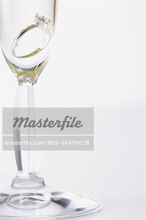 Glass of Champagne with a diamond ring in it Glass of Champagne with a diamond ring in it