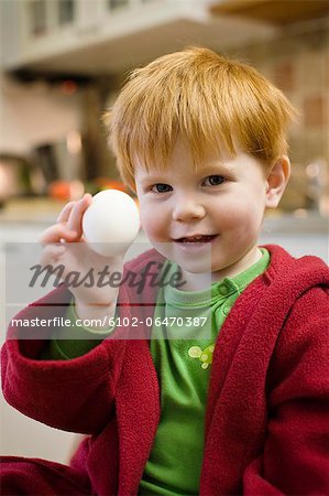 Boy holding an egg, Sweden.