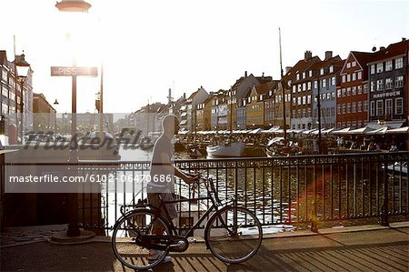 Man walking with a bicycle against the light, Denmark.