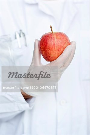 Laboratory technician holding apple