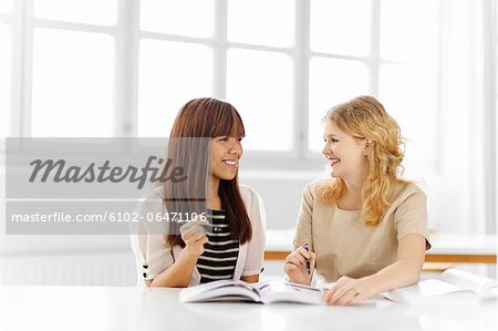 Two female students studying in library