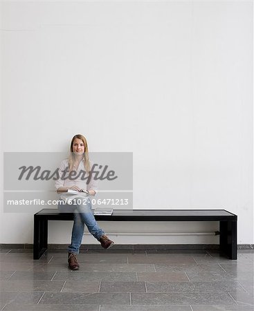 Young student sitting on bench Young student sitting on bench