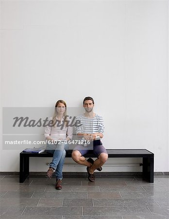 Young students sitting on bench Young students sitting on bench