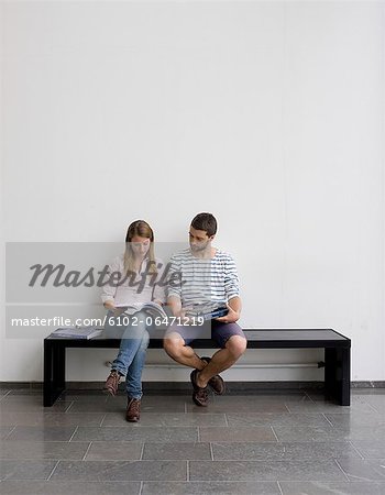 Young students sitting on bench Young students sitting on bench
