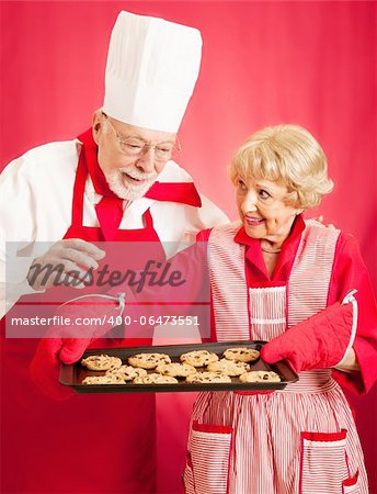 Chef admires the delicious chocolate chip cookies baked by a homemaker.