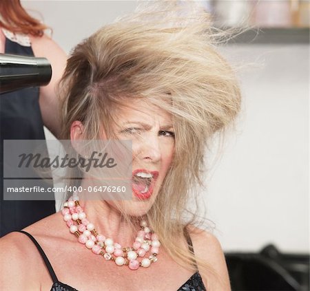 Picky lady with messy hair and blow dryer