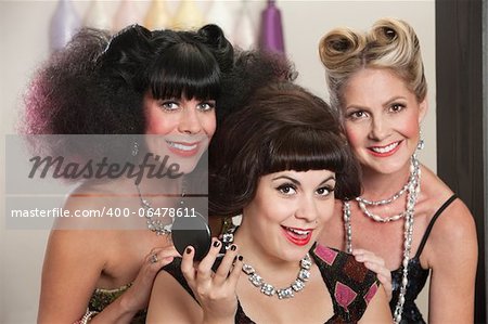 Three joyful Caucasian females in beauty salon