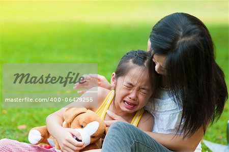 Mother is comforting her crying daughter