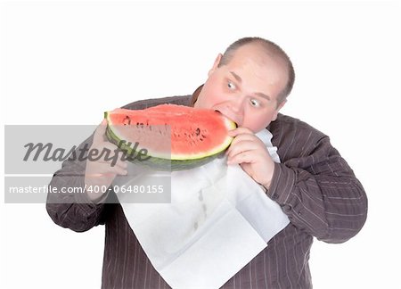 Fat man with a serviette around his neck as a bib tucking into a large slice of fresh juicy watermelon with a look of anticipation and glee isolated on white