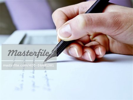 Photography closeup of the hand of a woman about to write