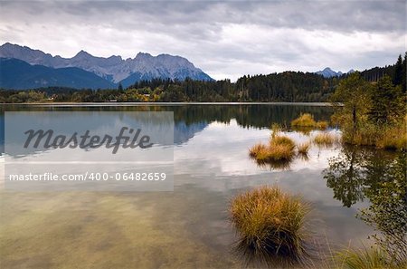 calm clouded landscape with wild lake Barmsee and mountains in Bavarian Alps