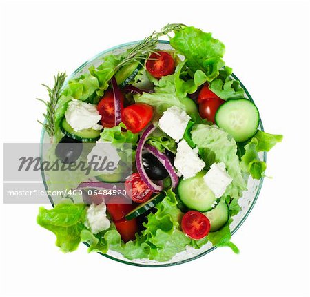 Mixed salad in a glass bowl on a white background