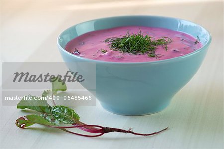 Chl?odnik - cold beetroot soup in a bowl on a wooden table. Seasonal dish.