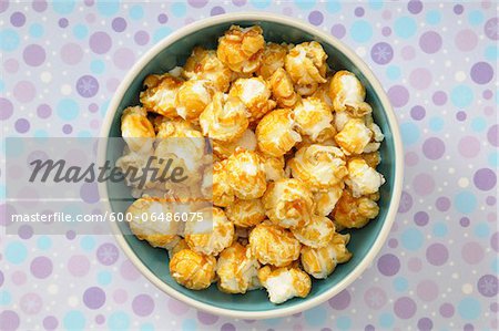 Overhead View of Caramel Popcorn in Bowl on Purple Polka Dot Background, Studio Shot