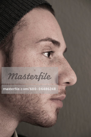 Close-up, Side View of Young Man wearing Woolen Hat, Studio Shot