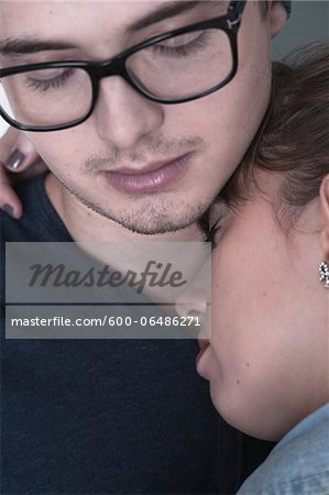 Close-up Portrait of Young Couple Embracing with Eyes Closed