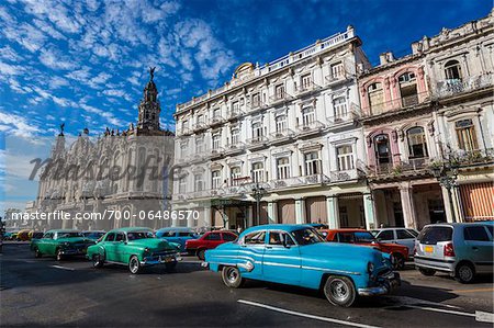 Classic Cars Driving by Great Theatre of Havana and Hotel Inglaterra, Havana, Cuba