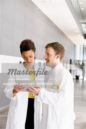 Doctors using tablet computer Doctors using tablet computer
