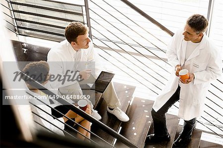 Doctors talking on steps in hospital