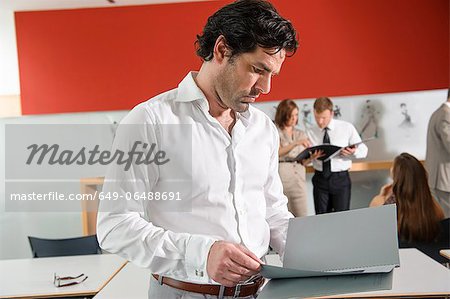 Businessman reading folder in office