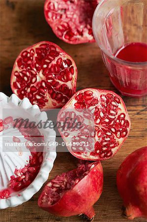 Halved pomegranates with juice