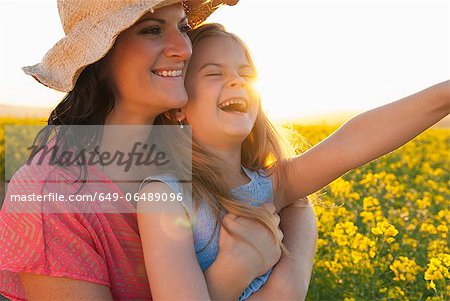 Mother and daughter hugging outdoors