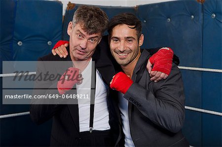Smiling boxers hugging in ring
