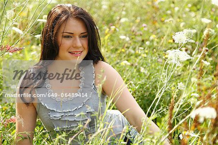 Woman sitting in tall grass