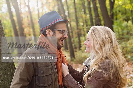 Smiling couple talking in forest