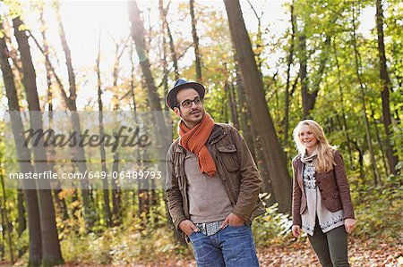 Smiling couple standing in forest