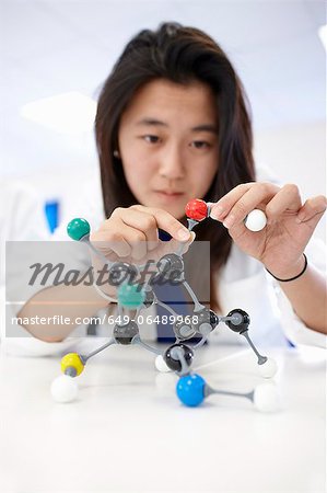 Student examining molecular model