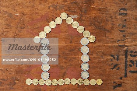 Euro coins in shape of house