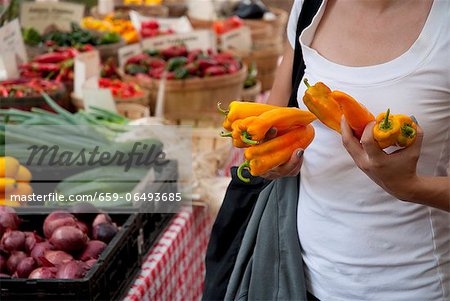 Woman Holding Banana Peppers at a Farmer's Market