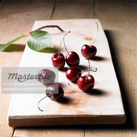 Cherries on a wooden board