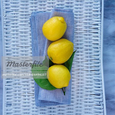Three lemons on a blue cloth