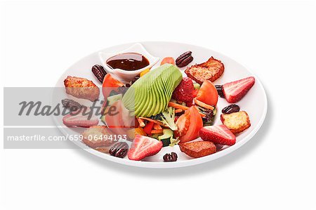 A vegetable salad with strawberries and nuts