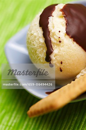 Pear ice cream with a biscuit and chocolate sauce
