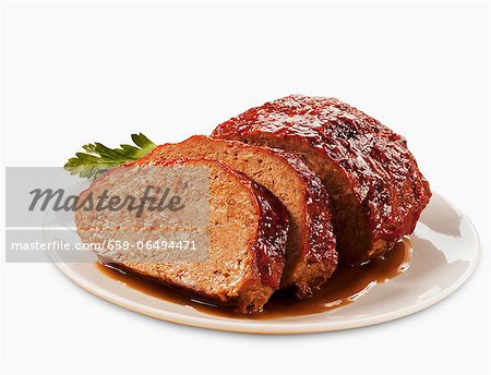 Partially Sliced Meatloaf on a Plate; White Background