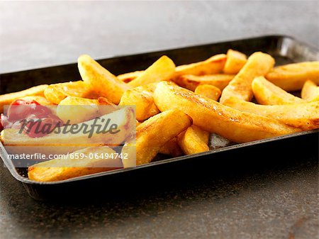 Ketchup on French fries, close-up, elevated view