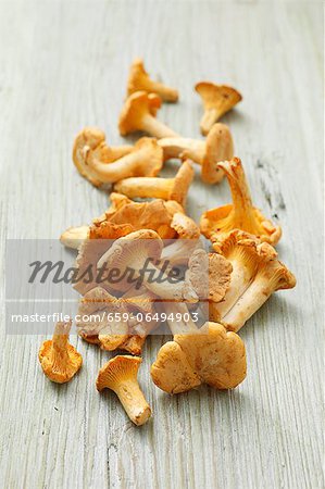 Fresh chanterelle mushrooms on a wooden surface