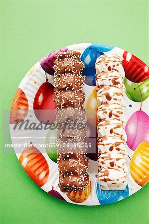 Marshmallow kebabs on a colourful paper plate