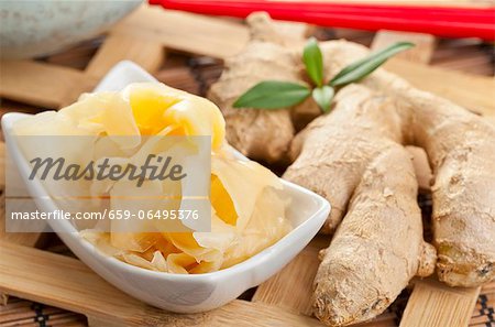 Gari - ginger marinated in soy sauce - with a piece of ginger next to it